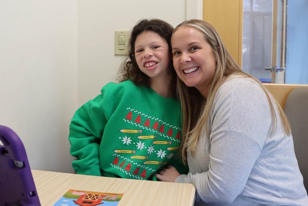 Abby Tappert smiles with a student