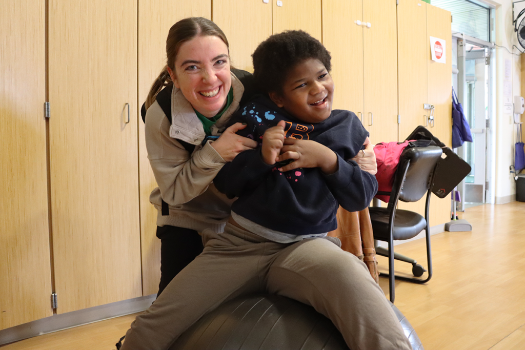 Teaching Assistant Amanda Edwards smiles with a student