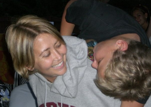 Rachel smiles with a student