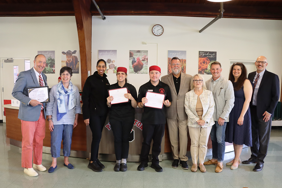 Eden participants smile with their parents and Eden staff members
