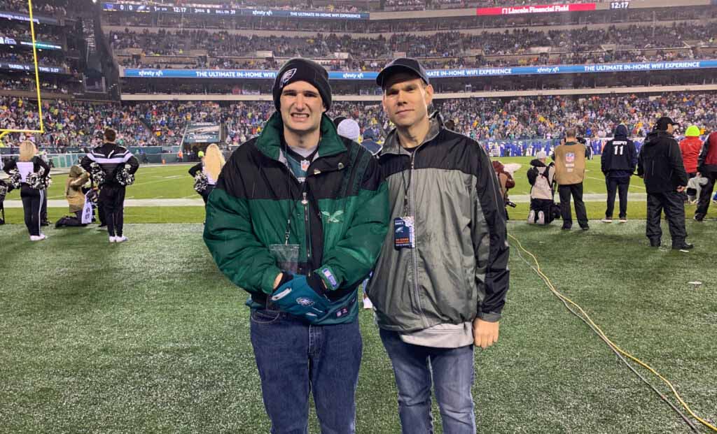 Eden participant Chris and senior DSP Joe on the field during the Giants-Eagles game on December 9.