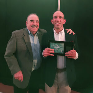 Norman Greenberg smiles with his son Steven, who is proudly holding his 30th anniversary plaque from Wawa.